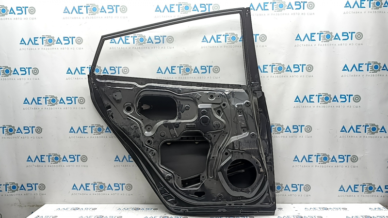 The bare rear left door of a Toyota Prius 50 16-20 is dented