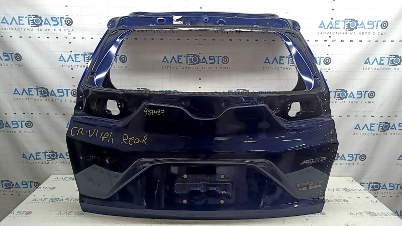 The trunk door is bare, Honda CRV 17-22, electric, blue B-588P, dented, metal torn, sealant cracked
