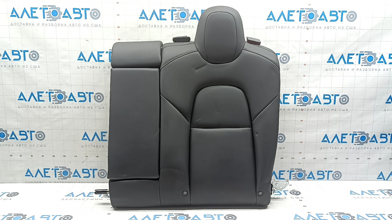 The back of the rear row of seats, left, Tesla Model 3 18-23, black leather, with a belt and heating, is wrinkled
