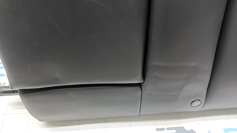 The back of the rear row of seats, left, Tesla Model 3 18-23, black leather, with a belt and heating, is wrinkled