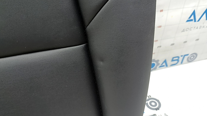 The back of the rear row of seats, left, Tesla Model 3 18-23, black leather, with a belt and heating, is wrinkled