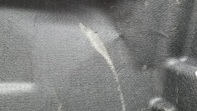 The trunk floor trim of the Mercedes X167 GLS 450 580 20-26 is black, torn, and needs dry cleaning