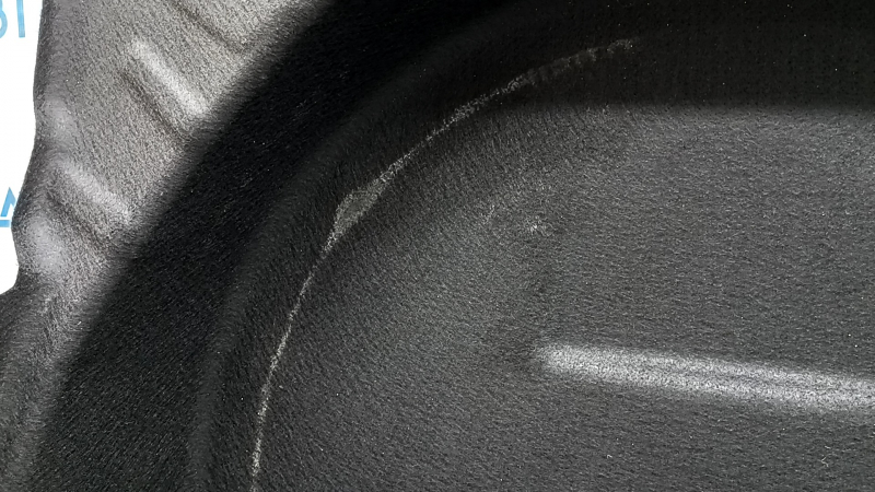 The trunk floor trim of the Mercedes X167 GLS 450 580 20-26 is black, torn, and needs dry cleaning