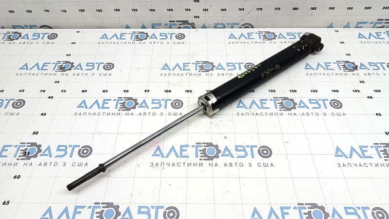 The rear left shock absorber of Toyota Prius 30 10-13 is dented and rusty