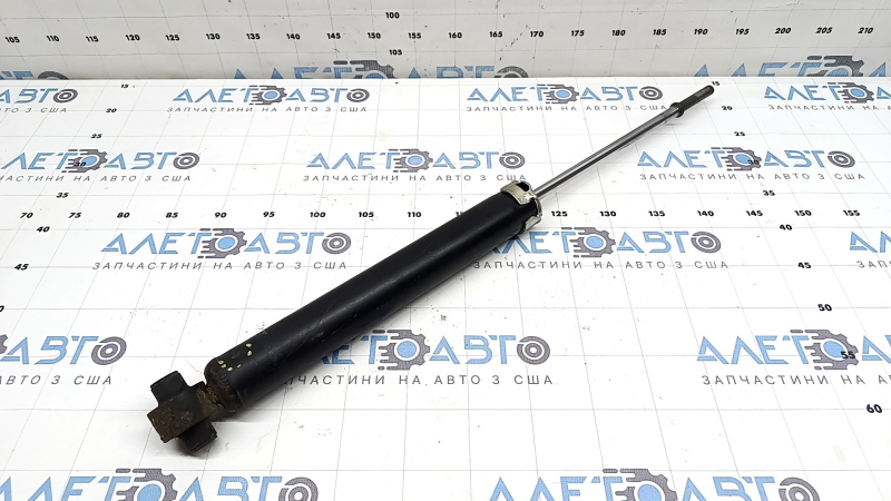 The rear right shock absorber of Toyota Prius 30 10-13 is dented and rusty