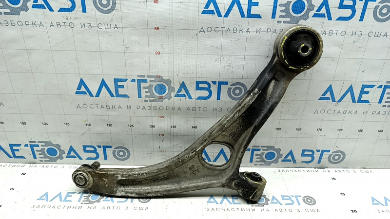 The lower front left control arm of a Hyundai Sonata 11-15 hybrid has torn silent blocks and a broken stopper