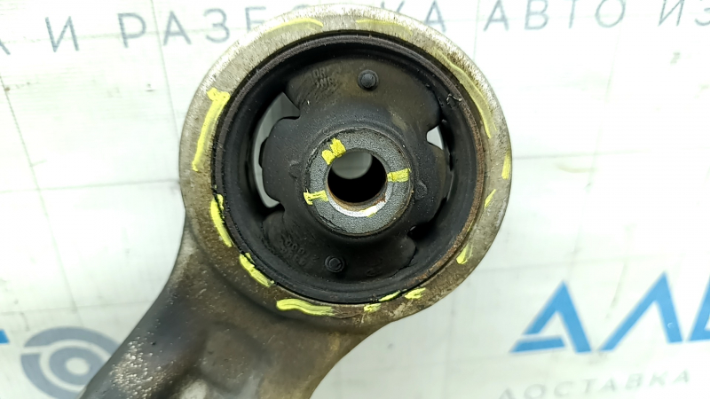 The lower front left control arm of a Hyundai Sonata 11-15 hybrid has torn silent blocks and a broken stopper