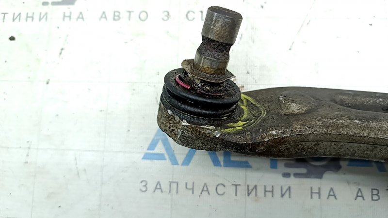 The lower front left control arm of a Hyundai Sonata 11-15 hybrid has torn silent blocks and a broken stopper