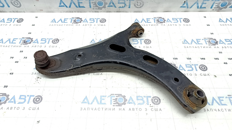The lower front left control arm of a Subaru Forester 19-24 SK is rusty and the silent block is torn
