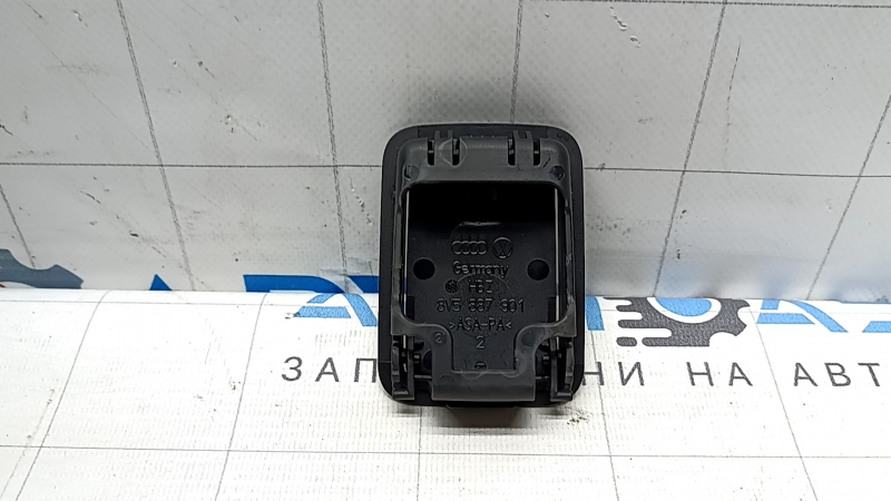 The child seat mounting plug in the rear shelf of the Audi A3 22-26 is black, in the shelf