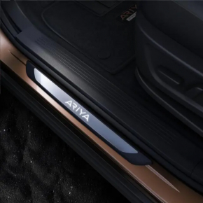 A set of door sills for the Nissan Ariya 23-25, black with chrome insert and backlighting.