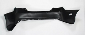 The rear bumper of a Toyota Camry V55 15-17 USA is black and dented, torn, and has broken fasteners.