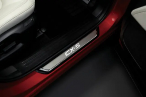 A set of black door sill plates for the Mazda CX-5 17-25 with chrome insert and lighting