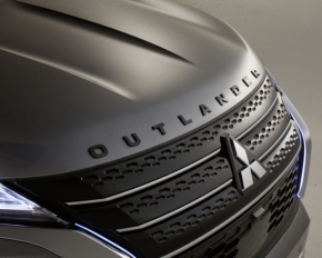 The hood emblem with the word "OUTLANDER" appears black on the Mitsubishi Outlander 22-25.