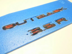 The Outback emblem on the Subaru Outback 10-14 trunk door.